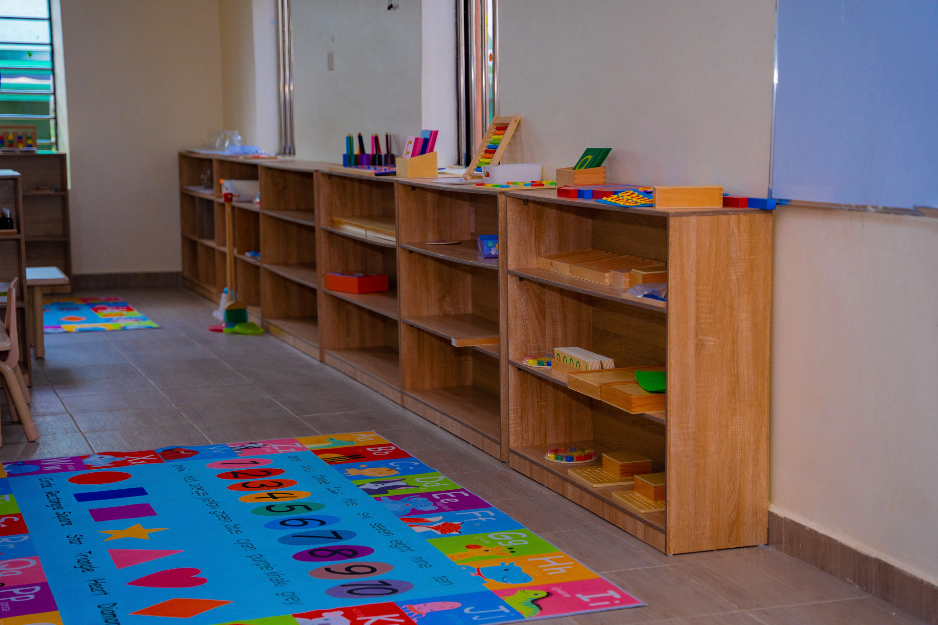 Montessori learning shelves with hands-on materials in our classroom